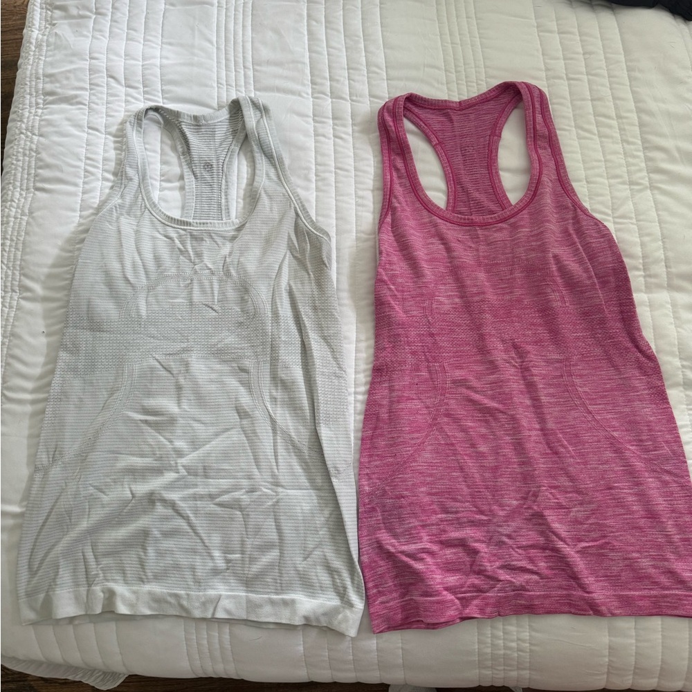 Two Lululemon Swiftly Tech tank tops size 6 in white and pink